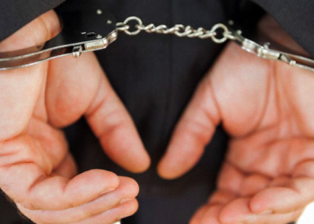 Handcuffed business criminal --- Image by © Wavebreak Media Ltd./Corbis