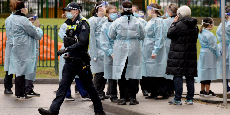 Dozens of workers put on their PPE before heading into locked down towers. Picture: Andrew Henshaw