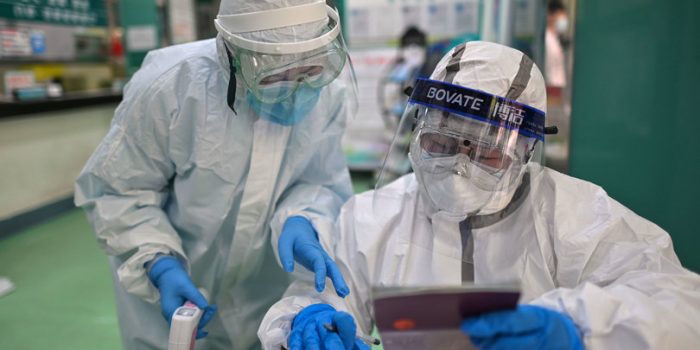 Medical workers check information as they take swab samples from people to be tested for the COVID-19 novel coronavirus in Wuhan, China's central Hubei province on April 16, 2020. - China has largely brought the coronavirus under control within its borders since the outbreak first emerged in the city of Wuhan late last year. (Photo by Hector RETAMAL / AFP) (Photo by HECTOR RETAMAL/AFP via Getty Images)