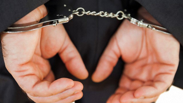 Handcuffed business criminal --- Image by © Wavebreak Media Ltd./Corbis