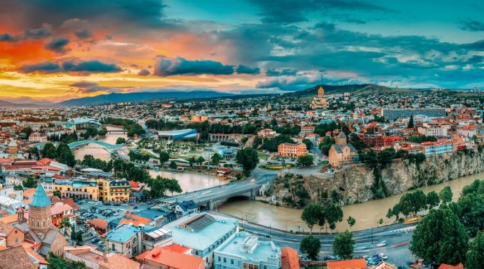 Tbilisi, Georgia. Panorama Cityscape Of Summer Old Town. Metekhi Church Of Assumption In Historic Neighborhood Of Tbilisi During Beautiful Sunrise. Central Part Of City With Famous Landmarks.