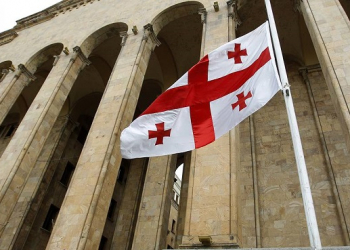 The Georgian national flag flies at half-mast in front of the parliament building during a day of mourning in Tbilisi June 7, 2013. A suicide bomber detonated a small truck loaded with explosives in southern Afghanistan, killing seven Georgian soldiers, NATO and Georgian officials said on Friday, and the Afghan Taliban claimed responsibility. REUTERS/David Mdzinarishvili (GEORGIA - Tags: MILITARY CONFLICT POLITICS)