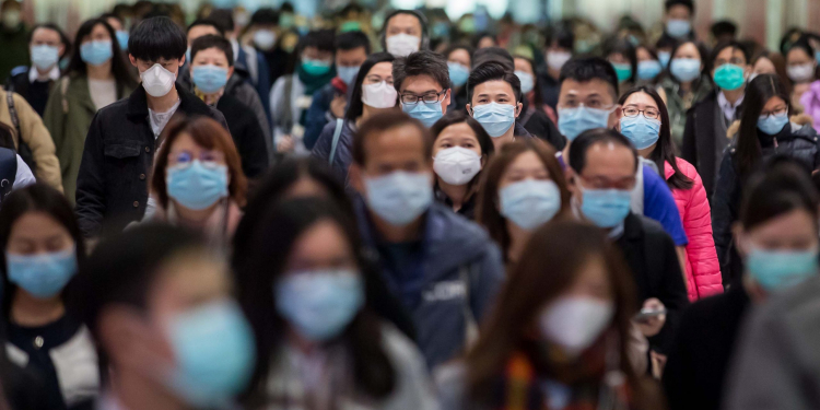 Commuters wearing protective masks walk through Hong Kong Station, operated by MTR Corp., in Hong Kong, China, on Wednesday, Jan. 29, 2020. Governments tightened international travel and border crossings with China as they ramped up efforts to stop the spread of the disease. Photographer: Paul Yeung/Bloomberg via Getty Images