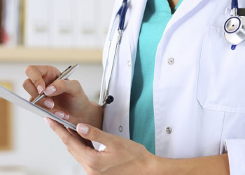 Female medicine doctor hand holding silver pen writing something on clipboard closeup. Medical care, insurance, prescription, paper work or career concept. Physician ready to examine patient and help