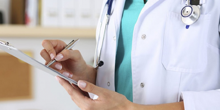 Female medicine doctor hand holding silver pen writing something on clipboard closeup. Medical care, insurance, prescription, paper work or career concept. Physician ready to examine patient and help