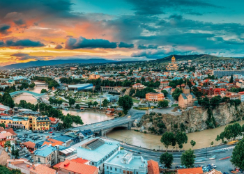 Tbilisi, Georgia. Panorama Cityscape Of Summer Old Town. Metekhi Church Of Assumption In Historic Neighborhood Of Tbilisi During Beautiful Sunrise. Central Part Of City With Famous Landmarks.
