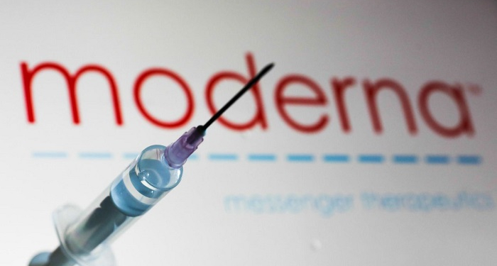 Medical syringe is seen with Moderna company logo displayed on a screen in the background in this illustration photo taken in Poland on June 12, 2020. American biotech company Moderna has announced on June 11 that will start final stage of covid-19 vaccine trial in July. (Photo Illustration by Jakub Porzycki/NurPhoto via Getty Images)