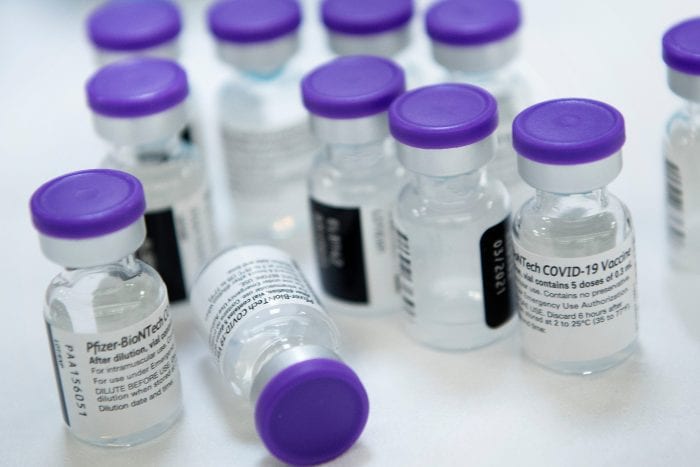 Vials of undiluted Pfizer COVID-19 vaccine are  prepared to administer to staff and residents at the Goodwin House Bailey's Crossroads, a senior living community in Falls Church, Virginia, on December 30, 2020. (Photo by Brendan Smialowski / AFP) (Photo by BRENDAN SMIALOWSKI/AFP via Getty Images)