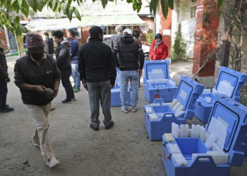 Health workers and officers stand by empty vaccine storage cold boxes that will be filled with COVID-19 vaccines to be transported to various districts of the state, in Imphal, in the northeastern Indian state of Manipur, Thursday, Jan. 14, 2021. India started inoculating health workers Saturday, Jan. 16 in what is likely the world's largest COVID-19 vaccination campaign, joining the ranks of wealthier nations where the effort is already well underway. (AP Photo/Yirmiyan Arthur)